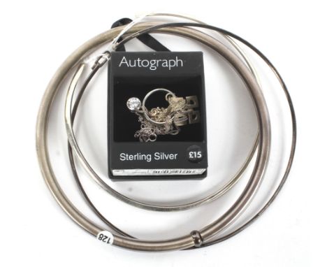 An assortment of silver and white metal jewellery. Comprising three Torq, a ring and a silver pendant on chain