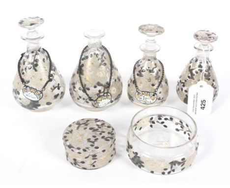 An assortment of vintage Parisian cologne/scent bottles and dishes. With enamel decoration in the form of flowers, three with