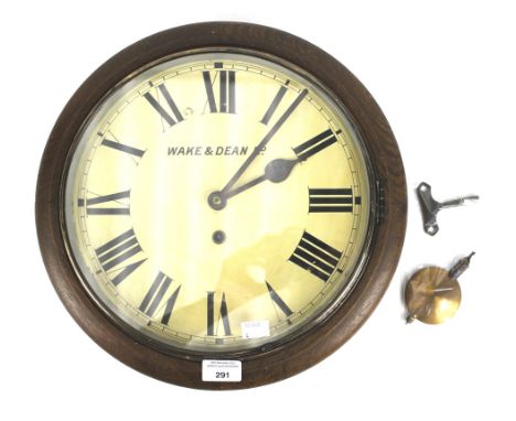 A Walker and Dean, eight day circular wall clock. The cream dial with Roman numerals, in a circular oak frame, Diam 38cm