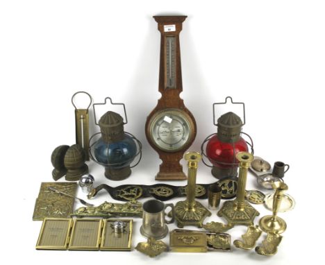 An assortment of collectables. Including a barometer, two lamps, a pair of brass candlesticks and horse brasses
