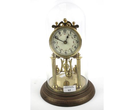 An early 20th century brass torsion clock. The enamel dial with Arabic numerals and decorated with floral details, marked for