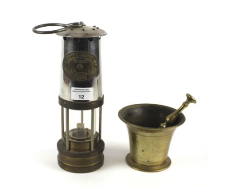 A brass miner's lamp by Thomas &amp; Williams of Aberdare and a brass mortar and pestle. Lamp numbered '179066', H26cm (exclu