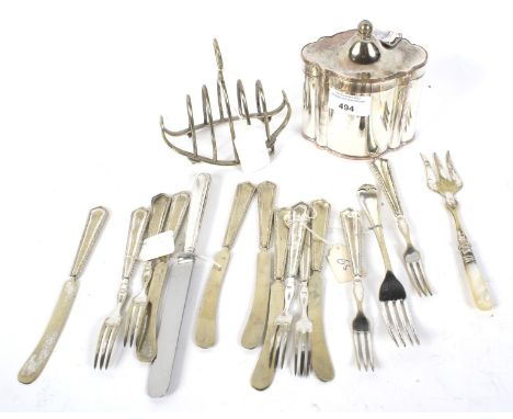 An assortment of silver plate. Comprising a tea caddy, toast rack and flatware