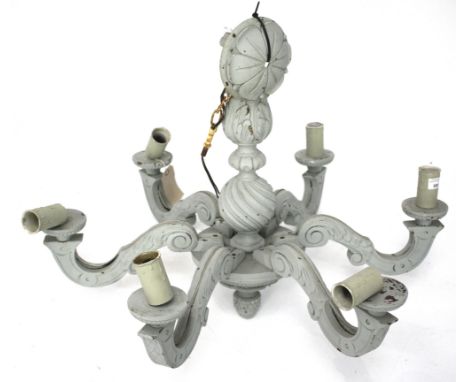 A carved wooden six branch chandelier. Painted grey with plastic candle holders, attached to a metal chain, H65cm (excluding 