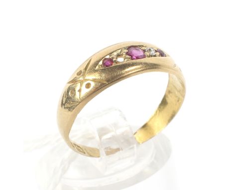 An 18ct gold ruby and diamond ring. Featuring alternating stones (one diamond missing) and a carved band, weight 2.0g, size K