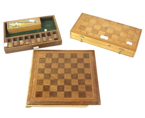 An assortment of board games. To include a wooden chess board, dominoes, travelling chess/draughts set, etc