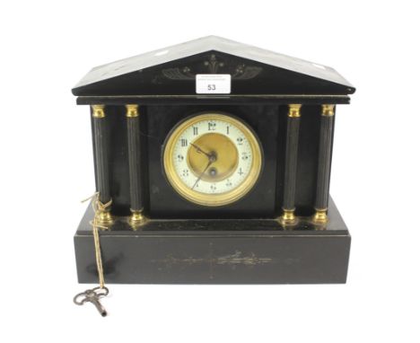 A late 19th century slate mantel clock. The dial with enamel chapter ring with Arabic numerals denoting hours, four gilt moun