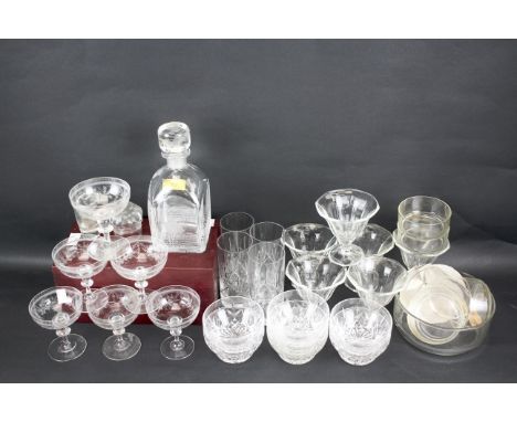 An assortment of glassware. Including six etched champagne coupes,six Art Deco style glasses, seven cut glass pudding bowls, 