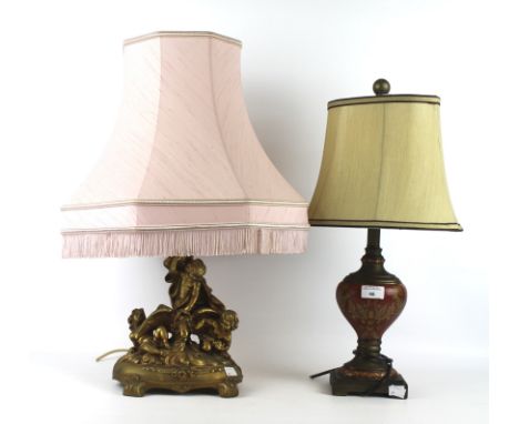 Two table lamps. Comprising: a gilt resin table lamp cast with cherubs on cloud-moulded base and another decorated in the 19t