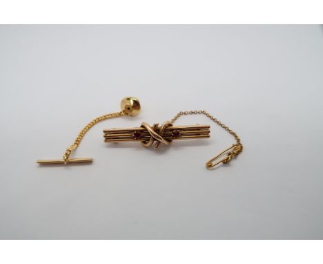 A 14ct yellow gold (tested) brooch with rubies, approx 4cm, approx 3.8 grams, and a tie pin with ruby and diamonds, head 15ct