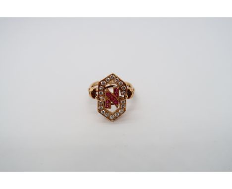 An approx 18ct (tested) yellow gold diamond and ruby ring - the head with open work as initials 'S' and 'N' set with round cu