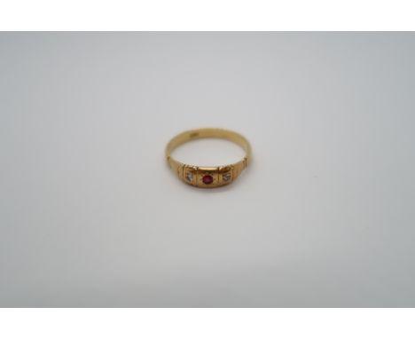 An 18ct yellow gold hallmarked ring with diamonds and ruby, size V, approx 4.6 grams 