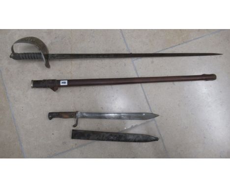 A sword and scabbard and a bayonet 