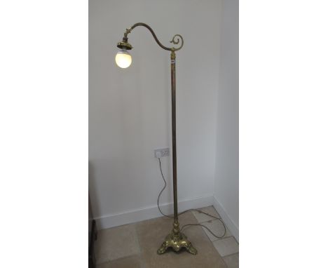 A tall 20th century brass standard lamp - missing its shade, in working order