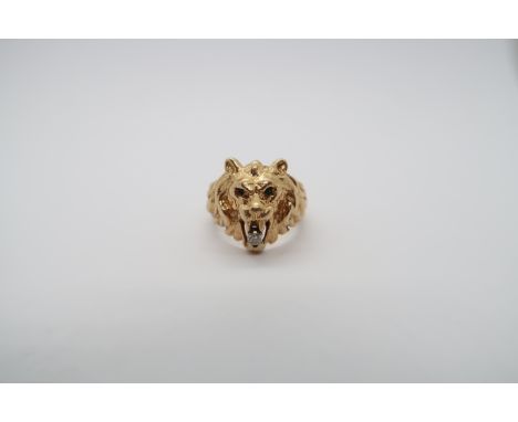 A gold ring in the form of a lion with a small diamond - tests as 14ct - ring size J/K - approx weight 10 grams 