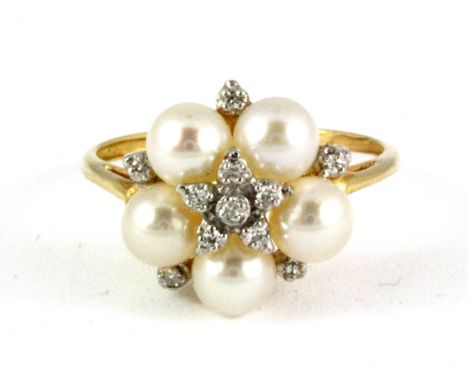 A 9ct yellow gold (stamped 10k) pearl and diamond set cluster ring, Dia. 1.4cm, (O).