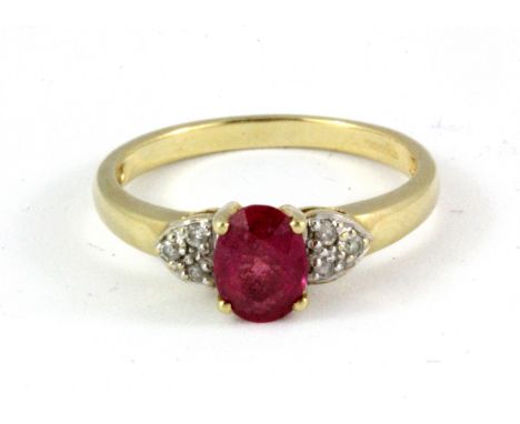 A 9ct yellow gold ring set with an oval cut Burmese ruby and diamond set shoulders, (N).