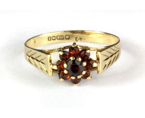 A 9ct yellow gold garnet set cluster ring, (O.5).