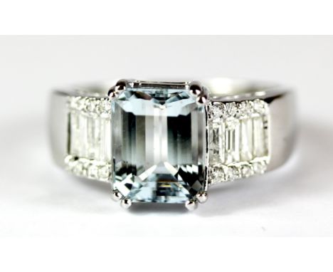 An 18ct white gold (stamped 750) ring set with a 2.5ct emerald cut aquamarine and brilliant and baguette cut diamond set shou