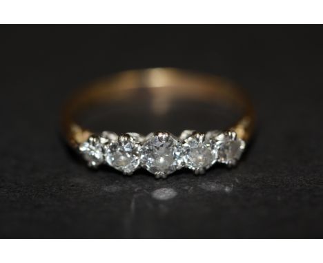 An 18ct yellow gold (worn stamp 18ct) ring set with five graduated brilliant cut diamonds, approx. 0.75ct overall, (P).