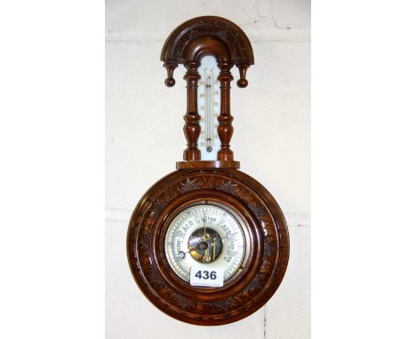 A carved walnutwood barometer, H. 37cm.