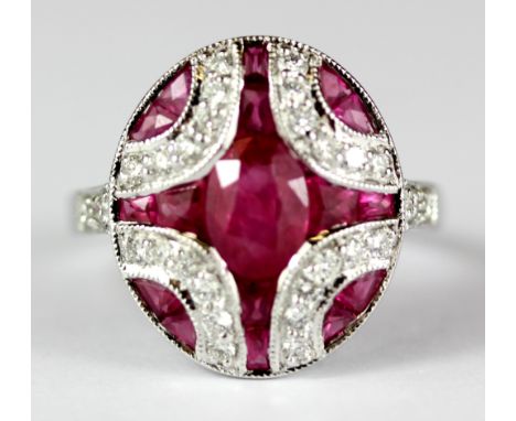 An Art Deco style 18ct white gold (stamped 18k) ring set with oval and mixed cut rubies and brilliant cut diamonds, 1.7 x 0.8