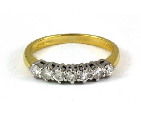 An 18ct yellow and white gold ring set with seven brilliant cut diamonds, approx. 0.50ct, (L.5).