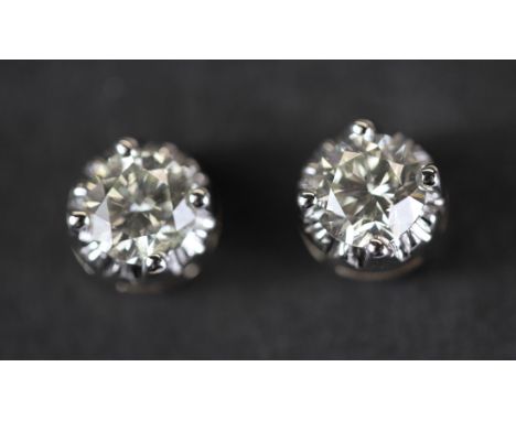 A pair of yellow metal (tested 18ct gold) brilliant cut diamond illusion set stud earrings, approx. 0.66ct overall, colour K-