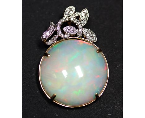 A 14ct yellow gold (stamped 585) pendant set with a large 20.59ct cabochon cut opal and brilliant cut diamonds, 3.5 x 2.5cm, 