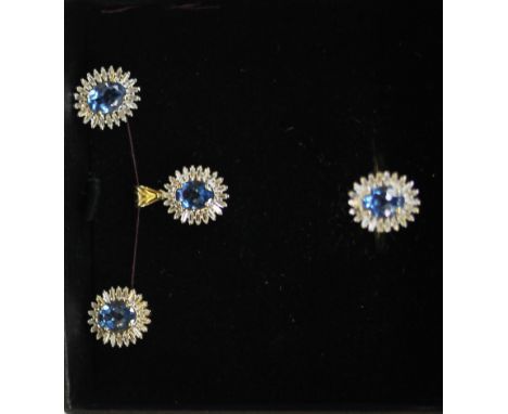 A boxed 9ct yellow gold (stamped 375) jewellery suite consisting of pendant, ring and pair of earrings, set with London blue 