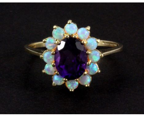 A 9ct yellow gold amethyst and opal set cluster ring, (O).