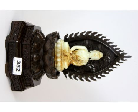 A Chinese carved jade figure of the seated Buddha on a carved hardwood stand, overall H. 28cm.