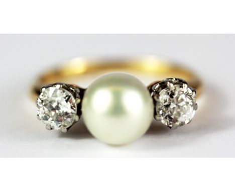 An 18ct yellow gold (stamped 18ct) ring set with a cultured pearl flanked by old European cut diamonds, approx. 1ct diamonds 