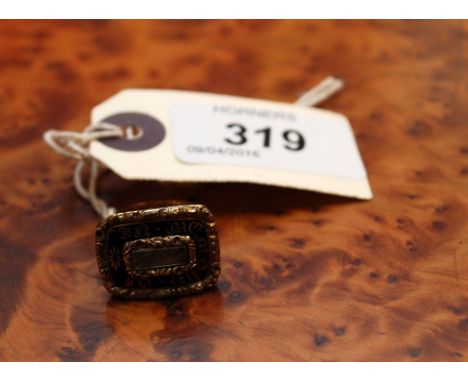 A MOURNING RING DATED 1823, THE FACE WITH BLACK ENAMEL AND GILT INSCRIPTION, THE BAND 22CT GOLD OF DIFFERENT DATE FROM INSCRI