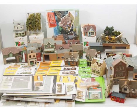 A large quantity of OO gauge accessories comprising various card and plastic kit built buildings, a large quantity of unbuilt
