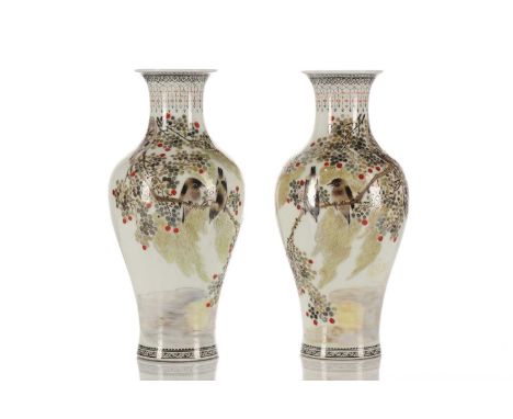 A pair of Chinese porcelain vases, Peoples Republic period, each painted with two birds on a leafy branch, a short poem verso