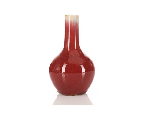 A Chinese sang de boeuf Tianquiping, the glaze with irregular shading throughout, on an unglazed foot, 17.5cm, on a later woo