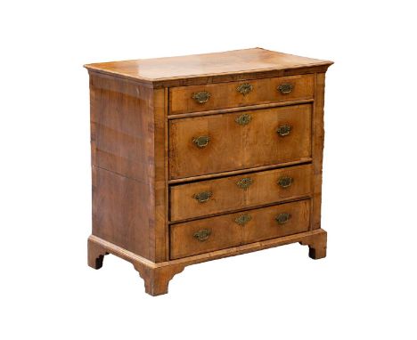 An early 18th-century regional walnut chest of four long drawers, with broad crossbanded and quarter, veneered top. With cros