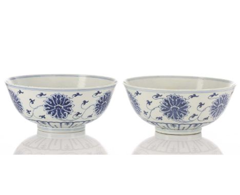 A pair of Chinese blue &amp; white lotus bowls, early to mid 20th century, the interior with a single lotus flower within two