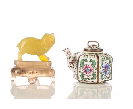 A Chinese yellow jade cat, Qing, the stone a uniform colour throughout, standing upon a carved stone stand, 7.5cm overall; an