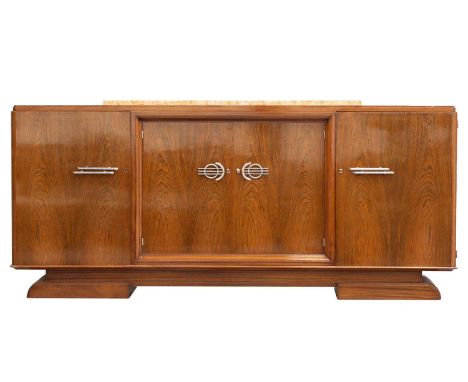 A Continental Art Deco walnut sideboard with raised marble top with central recessed cupboards flanked by a pair of moulded c