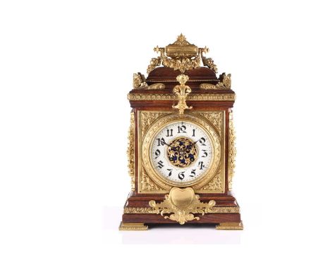 An early 20th century French 8-day oak cased mantle clock of architectural form with gilt metal neo-classical mounts. The por