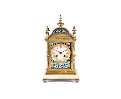 A French gilt metal and champleve enamel mantel clock, 19th century, with turned finials and columns, with white onyx dial an