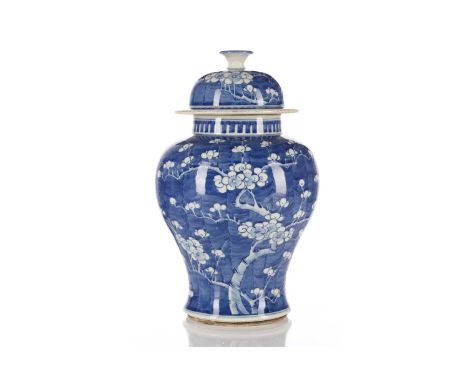 A Chinese porcelain blue &amp; white vase and cover, in the Kangxi style, of inverted baluster form painted with blossoming p