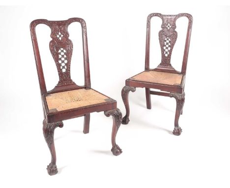 A pair of 18th century American, Pennsylvanian 'Queen Anne' red walnut side chairs, the splats pierced and carved with scroll