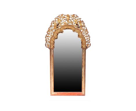A late 19th century carved lacquered and gilt arch-topped wall mirror with a cresting pierced and carved with figures amidst 