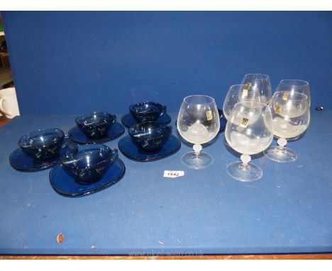 A set of blue glass cups and saucers (6) and a set of 'Lily' Brandy glasses (6).