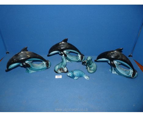 Three Poole pottery seals and three Poole pottery dolphins.