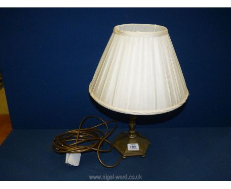 A brass Table Lamp having six sided base with bun feet and cream Laura Ashley silk shade.