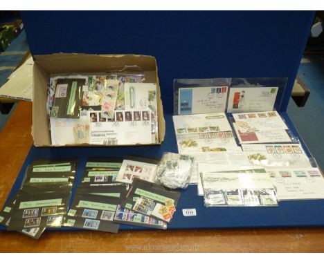 A box of loose stamps, mint G.B sets and First Day Covers.